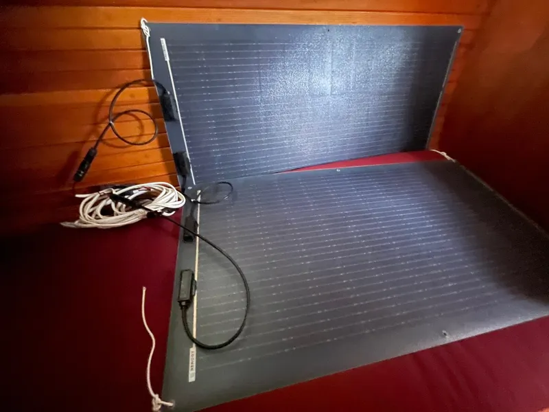 Slide: The Image of Flexible solar panels inside a 1980 Davidson 44 boat cabin, with visible wiring. - 19