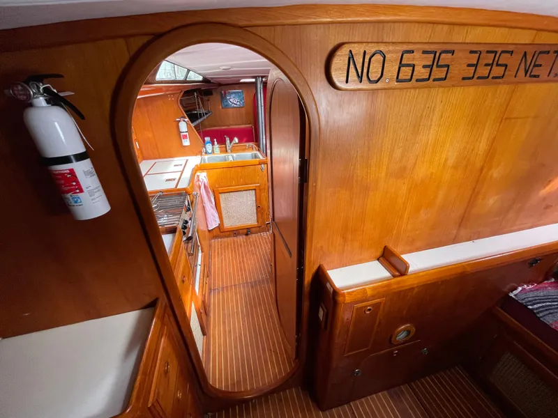 Slide: The Image of Interior of 1980 Davidson 44 yacht with wooden finish and compact kitchen area. - 20