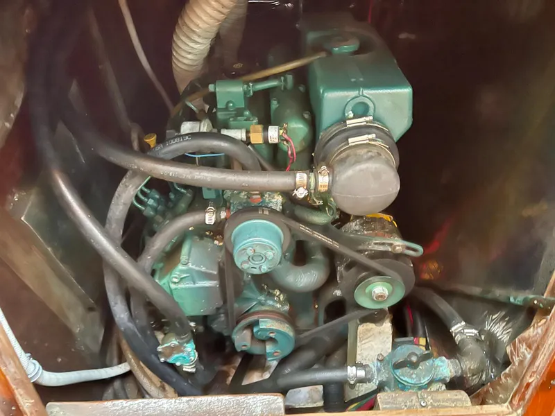 Slide: The Image of Engine compartment of a 1980 Davidson 44, showcasing mechanical components and hoses. - 22