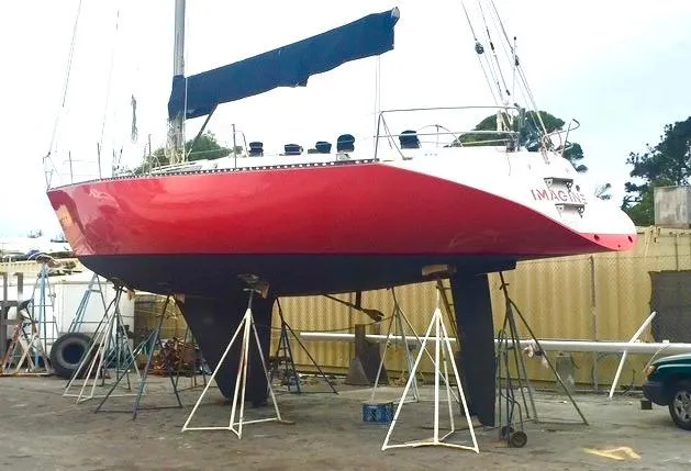 Slide: The Image of 1980 Davidson 44 sailboat with red hull on stands in a boatyard. - 3