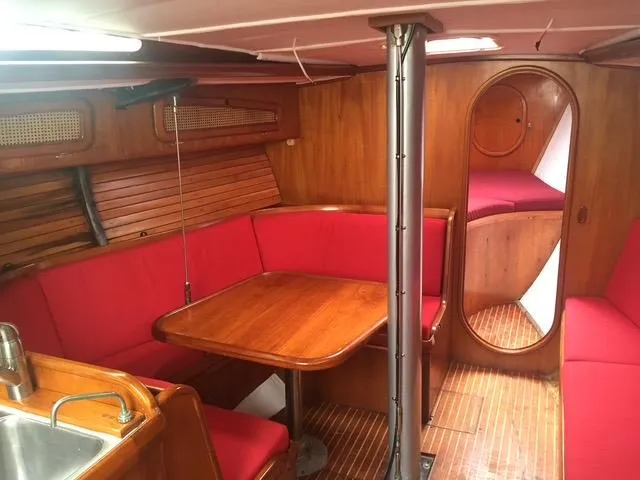 Slide: The Image of Interior of 1980 Davidson 44 yacht with red seating and wooden finishes. - 8