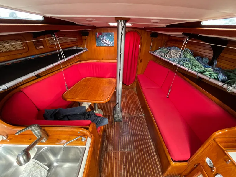 Slide: The Image of Interior of 1980 Davidson 44 sailboat with red seating and wooden finishes. - 9