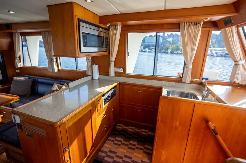 Slide: The Image of Luxurious 2006 Grand Banks 47 Europa yacht interior with kitchen and scenic window views. - 13
