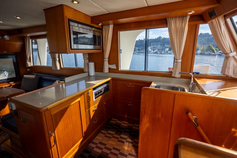 Slide: The Image of Interior of 2006 Grand Banks 47 Europa yacht with wooden cabinetry and waterfront view. - 14