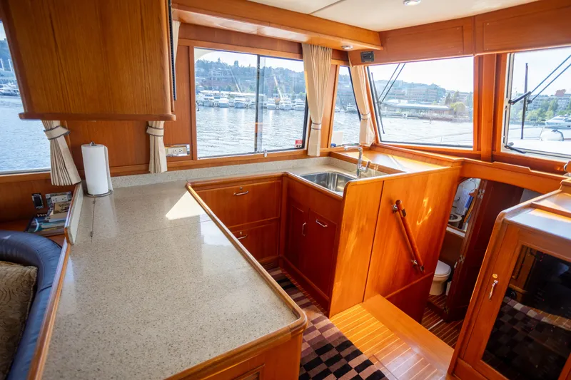 Slide: The Image of Luxurious 2006 Grand Banks 47 Europa yacht interior with elegant wood finishes and waterfront views. - 15