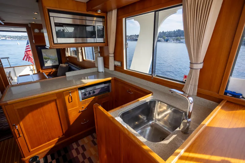 Slide: The Image of 2006 Grand Banks 47 Europa yacht interior with kitchen and ocean view. - 16