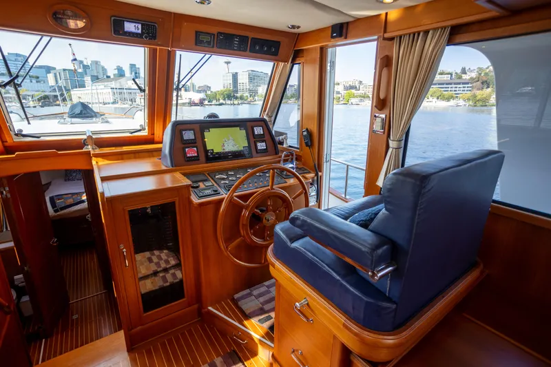 Slide: The Image of Pilothouse of 2006 Grand Banks 47 Europa yacht with navigation equipment and city view. - 17