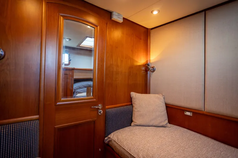 Slide: The Image of Cozy cabin interior of 2006 Grand Banks 47 Europa yacht with wooden door and soft lighting. - 25
