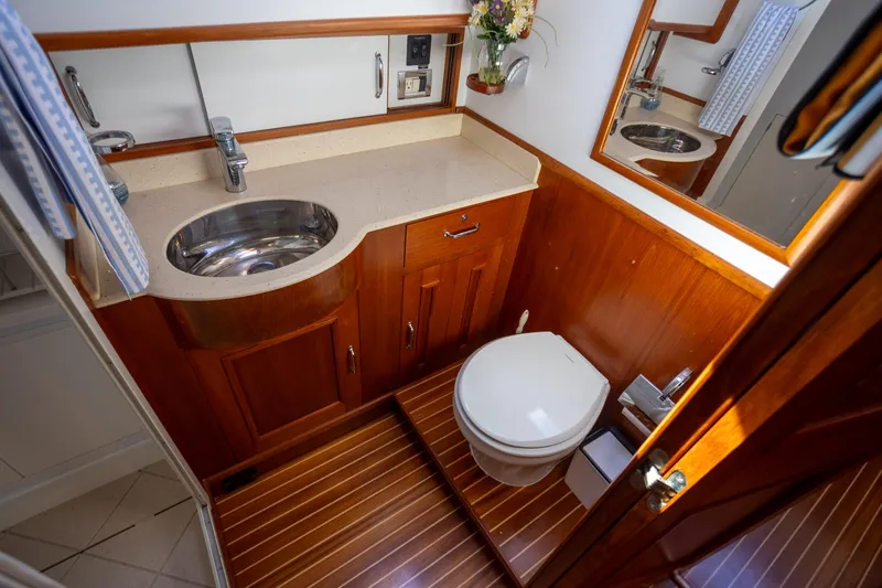 Slide: The Image of Luxurious 2006 Grand Banks 47 Europa yacht bathroom with wooden cabinetry and modern fixtures. - 26