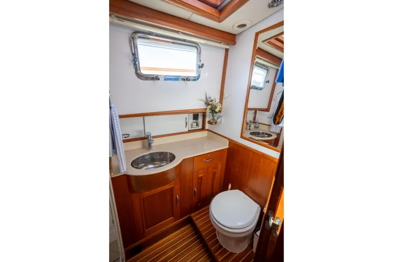 Slide: The Image of Luxurious 2006 Grand Banks 47 Europa yacht bathroom with wooden cabinetry and modern fixtures. - 27
