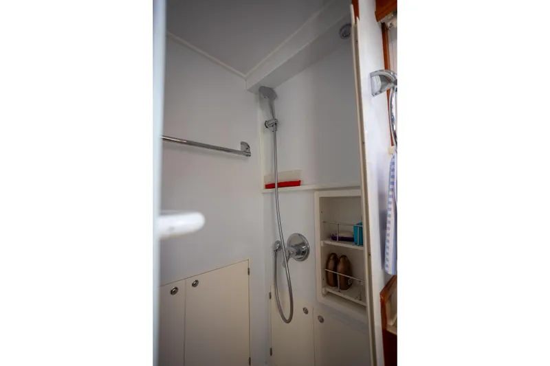 Slide: The Image of Shower area in 2006 Grand Banks 47 Europa yacht, featuring modern fixtures and storage. - 28