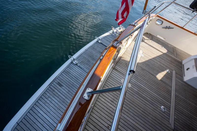 Slide: The Image of Deck of 2006 Grand Banks 47 Europa yacht with wooden flooring and railing. - 36