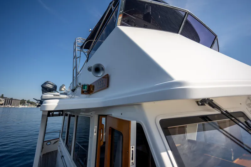 Slide: The Image of 2006 Grand Banks 47 Europa yacht on calm water under clear blue sky. - 37