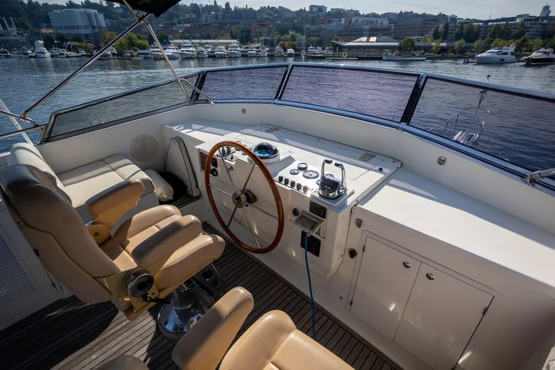 Slide: The Image of Helm of 2006 Grand Banks 47 Europa yacht with leather seats and wooden steering wheel. - 38