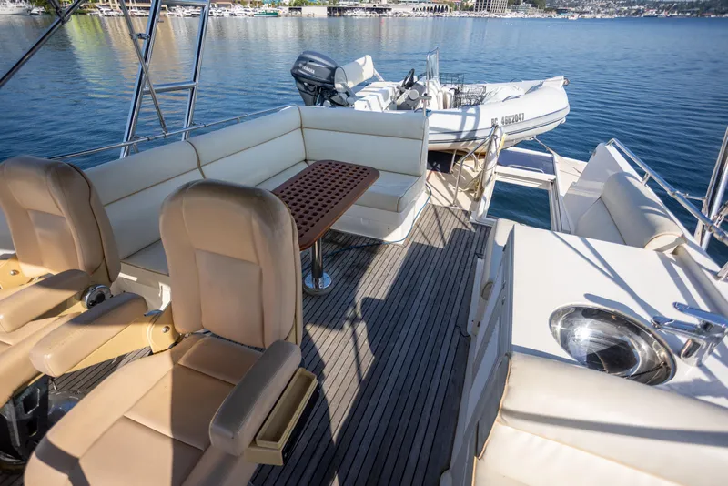 Slide: The Image of Luxurious 2006 Grand Banks 47 Europa yacht deck with seating and tender boat. - 39
