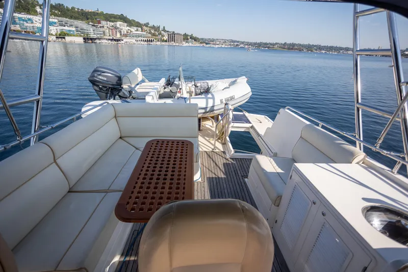 Slide: The Image of 2006 Grand Banks 47 Europa yacht deck with seating, table, and scenic waterfront view. - 40