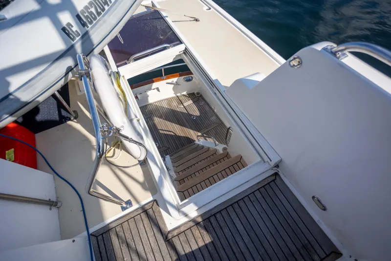 Slide: The Image of Stairway on 2006 Grand Banks 47 Europa yacht with teak decking and safety railings. - 43