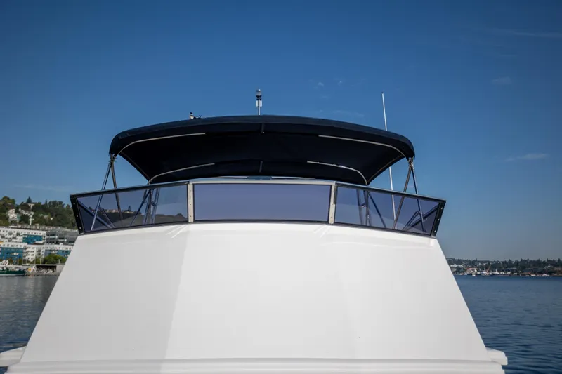 Slide: The Image of 2006 Grand Banks 47 Europa yacht on calm water, clear sky background. - 46