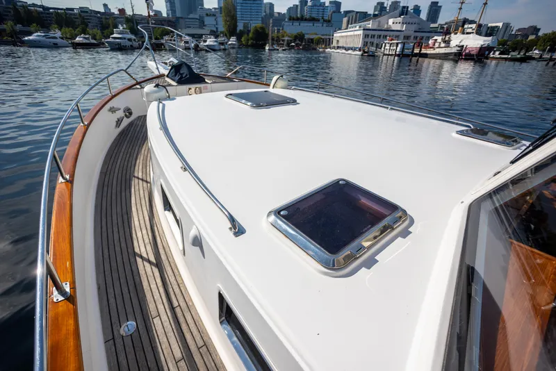 Slide: The Image of 2006 Grand Banks 47 Europa yacht deck with city skyline in background. - 48