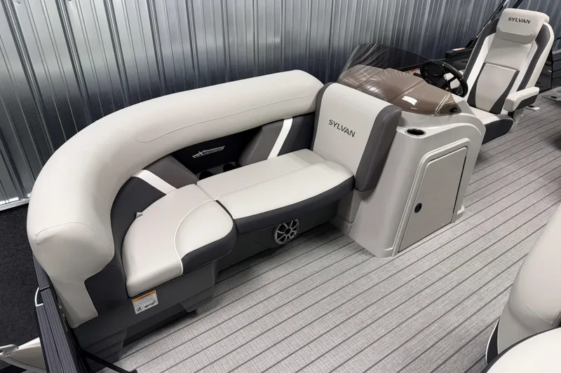 Slide: The Image of 2026 Sylvan MIRAGE X3 DLZ BAR pontoon boat interior with plush seating and modern design. - 2