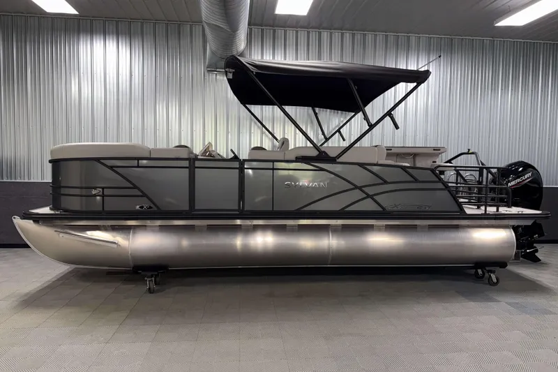 Slide: The Image of 2026 Sylvan MIRAGE X3 DLZ BAR pontoon boat in showroom, side view. - 23