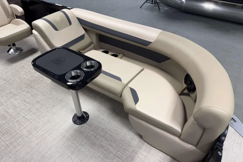 Slide: The Image of Luxurious seating in 2026 Premier 200 Sunscape RL boat with cup holders and table. - 21