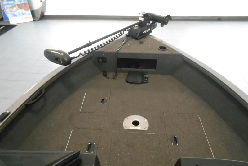 Slide: The Image of 2021 Crestliner 1650 Fish Hawk WT JS boat interior with trolling motor and carpeted deck. - 10