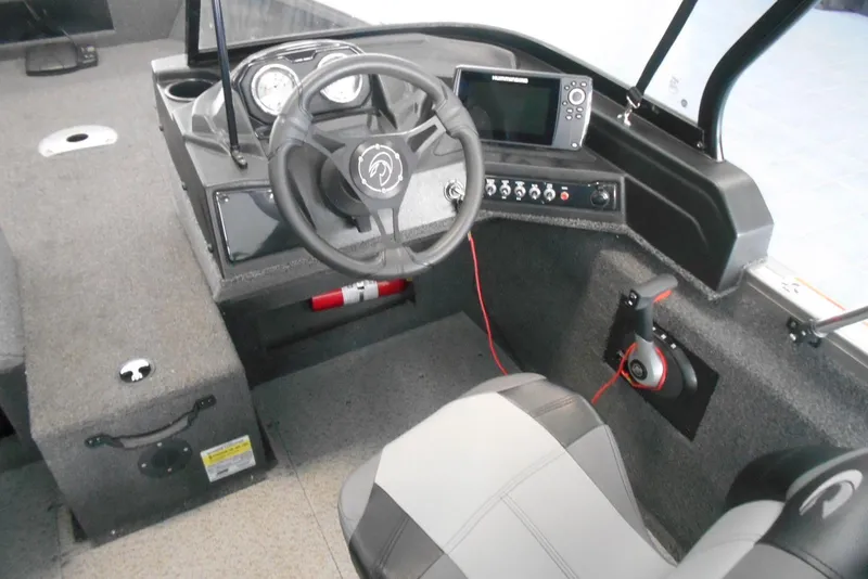 Slide: The Image of 2021 Crestliner 1650 Fish Hawk WT JS boat interior with steering wheel and control panel. - 12
