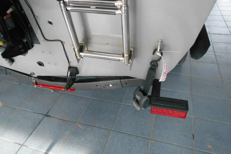 Slide: The Image of 2021 Crestliner 1650 Fish Hawk WT JS boat rear view with ladder and trailer light. - 17