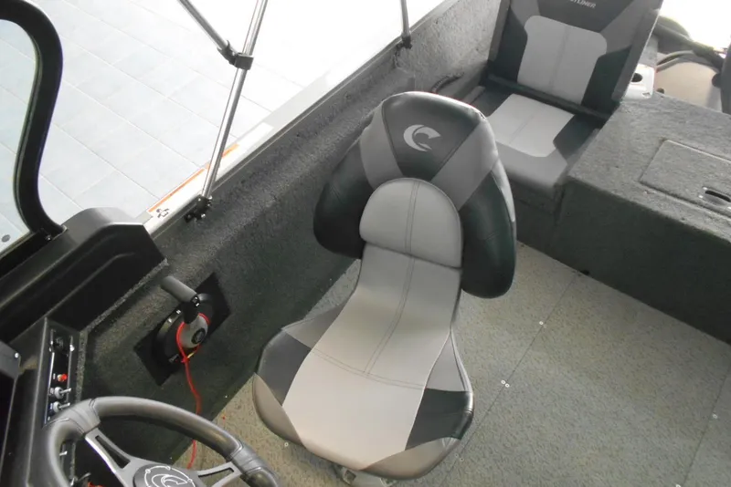Slide: The Image of 2021 Crestliner 1650 Fish Hawk WT JS boat interior with seating and steering wheel. - 7