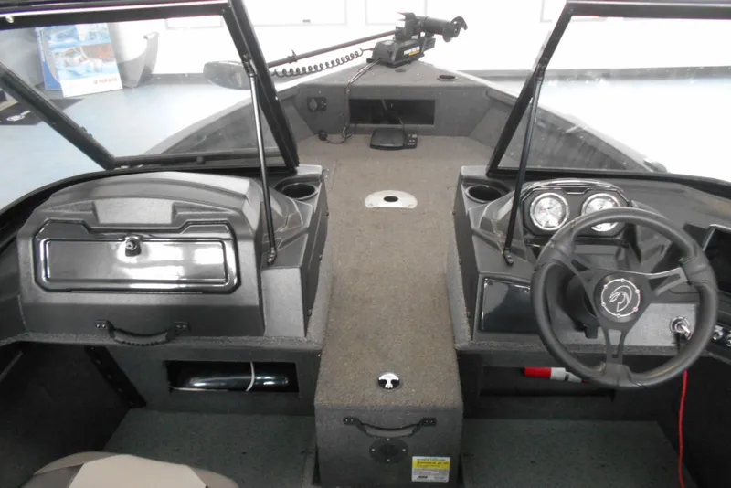Slide: The Image of 2021 Crestliner 1650 Fish Hawk WT JS boat interior with steering wheel and dashboard. - 9