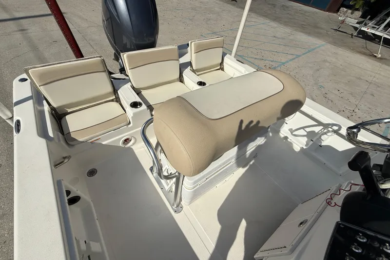 Slide: The Image of 2018 NauticStar boat interior with beige seating and steering console. - 11
