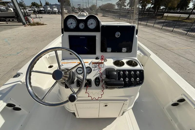 Slide: The Image of 2018 NauticStar boat console with steering wheel, gauges, and controls. - 12