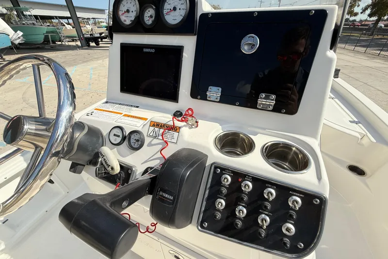 Slide: The Image of 2018 NauticStar boat dashboard with steering wheel, gauges, and control panel. - 13