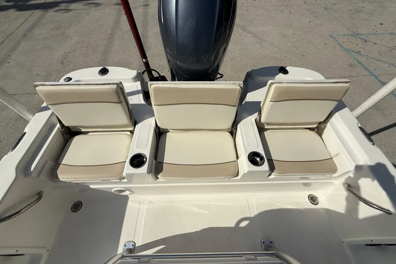 Slide: The Image of 2018 NauticStar boat with three beige seats and cup holders. - 14