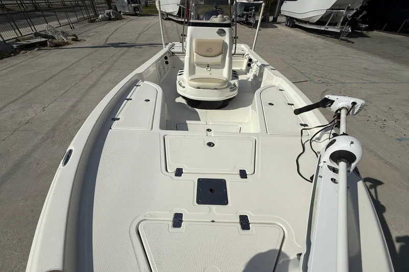 Slide: The Image of 2018 NauticStar boat deck with seating and trolling motor, parked on concrete. - 9
