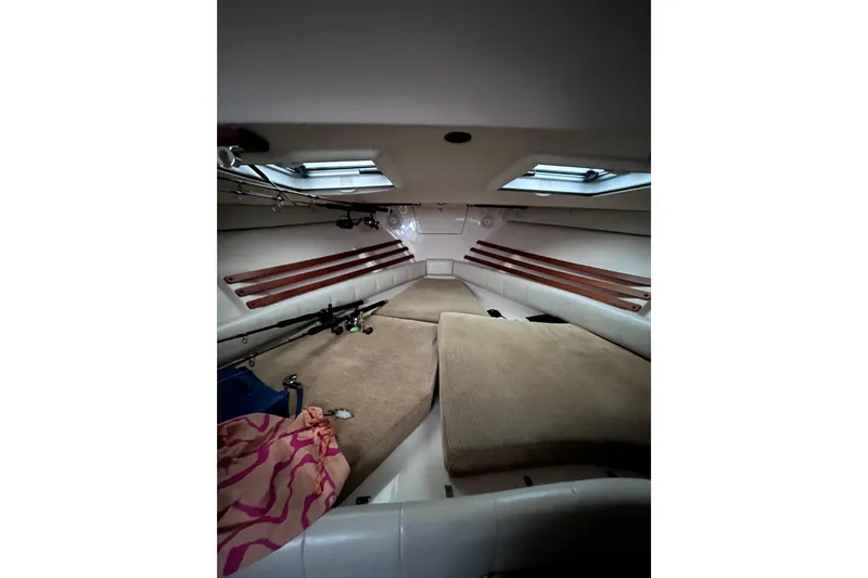 Slide: The Image of 2007 Grady-White Express 330 cabin interior with fishing rods and cushions. - 5