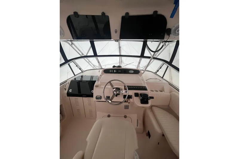 Slide: The Image of 2007 Grady-White Express 330 boat cockpit with steering wheel and control panel. - 7