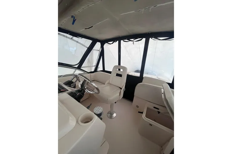 Slide: The Image of 2007 Grady-White Express 330 boat interior with helm and seating area. - 9