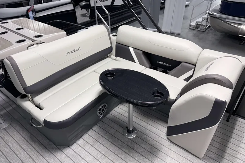 Slide: The Image of 2026 Sylvan MIRAGE X3 DLZ BAR boat interior with sleek seating and table. - 14