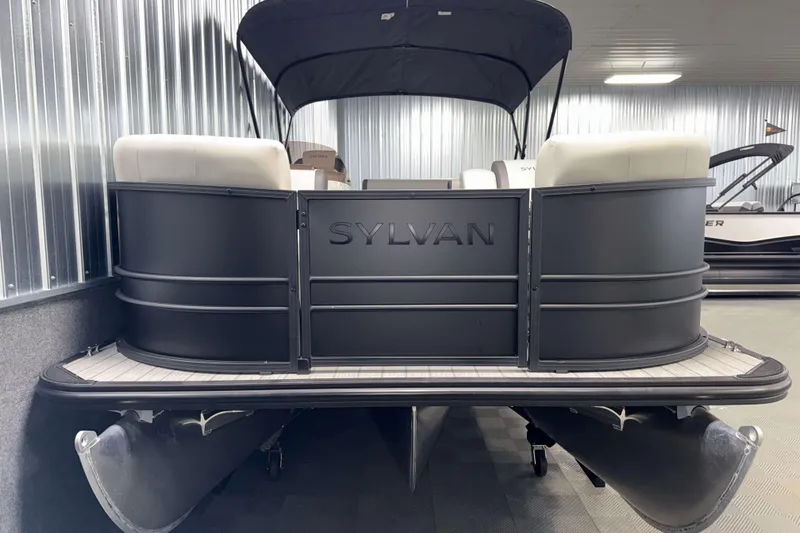 Slide: The Image of 2026 Sylvan MIRAGE X3 DLZ BAR pontoon boat in showroom, featuring sleek design and comfortable seating. - 22