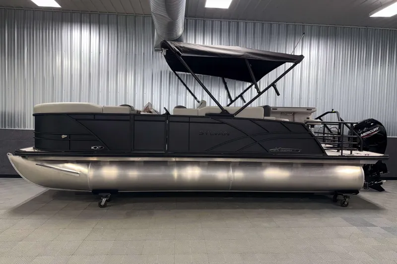 Slide: The Image of 2026 Sylvan MIRAGE X3 DLZ BAR pontoon boat in showroom, side view. - 25