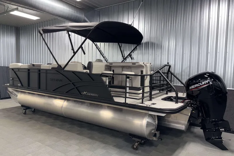 Slide: The Image of 2026 Sylvan MIRAGE X3 DLZ BAR pontoon boat with Mercury outboard motor in a showroom. - 27