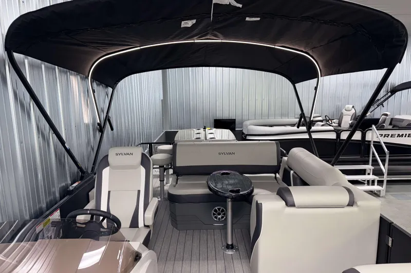 Slide: The Image of 2026 Sylvan MIRAGE X3 DLZ BAR pontoon boat interior with seating and canopy. - 29