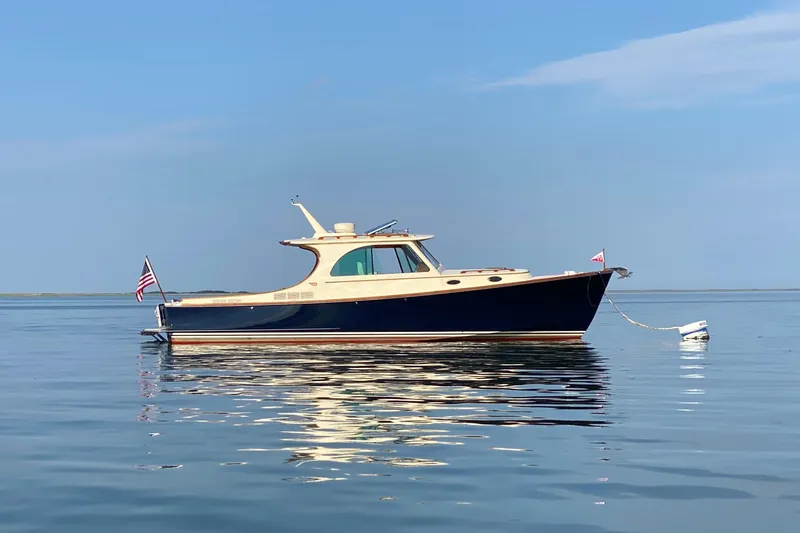 Slide: The Image of 2017 Hinckley Picnic Boat 37 MKIII on calm water, clear sky background. - 1