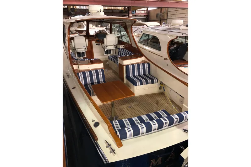 Slide: The Image of 2017 Hinckley Picnic Boat 37 MKIII with striped seating and wooden interior. - 12