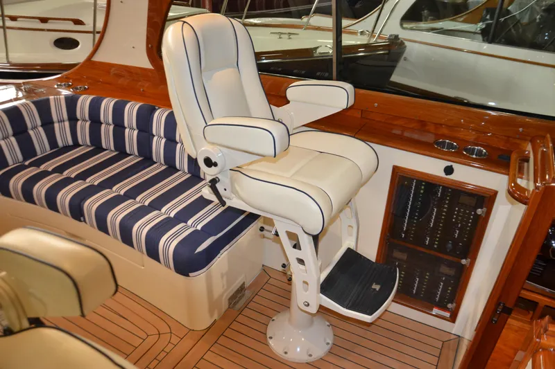 Slide: The Image of Luxurious interior of 2017 Hinckley Picnic Boat 37 MKIII with plush seating and elegant helm chair. - 16