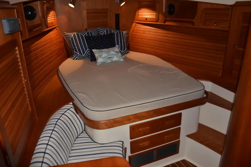 Slide: The Image of 2017 Hinckley Picnic Boat 37 MKIII cabin with cozy bed and wooden interior. - 20