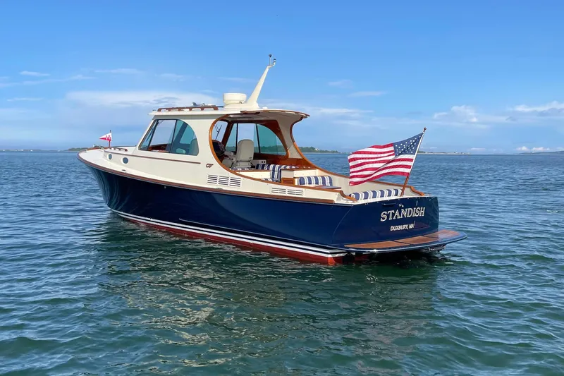 Slide: The Image of 2017 Hinckley Picnic Boat 37 MKIII on calm blue water, American flag waving. - 3