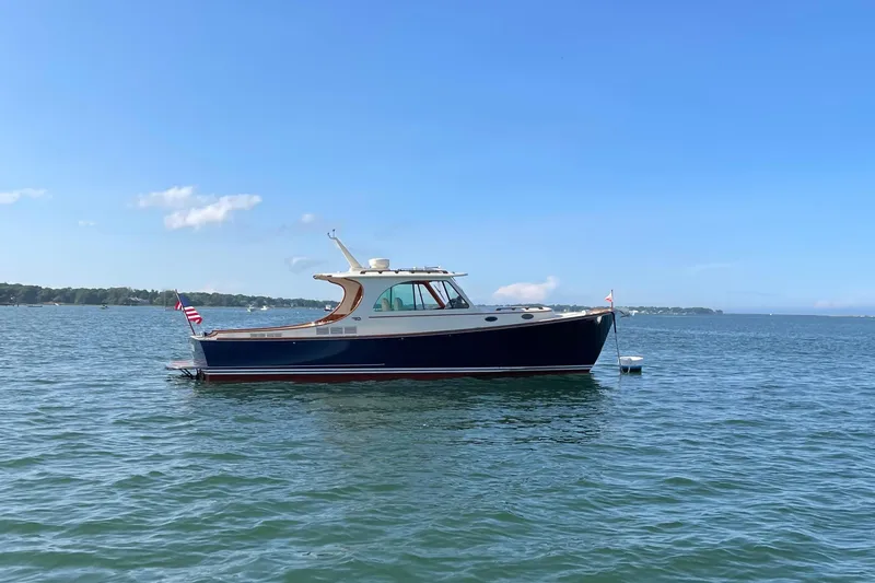 Slide: The Image of 2017 Hinckley Picnic Boat 37 MKIII on calm water under clear blue sky. - 5